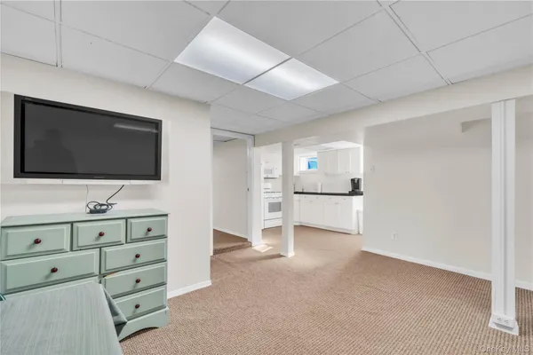 a living room with furniture and flat screen tv