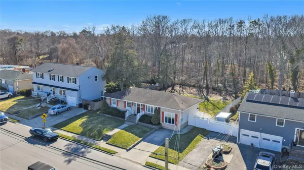 an aerial view of a house with swimming pool and a yard