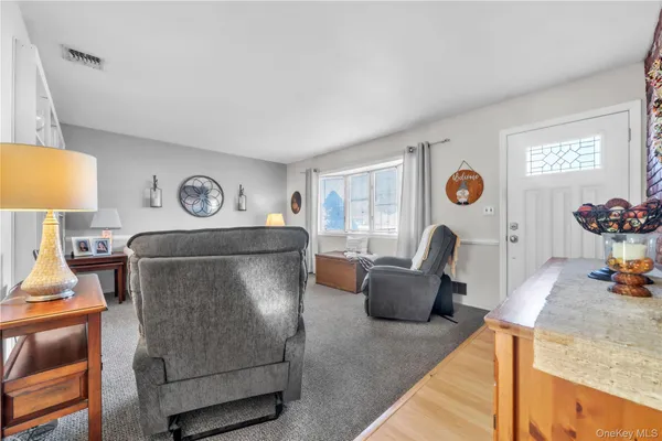 a living room with furniture and a lamp