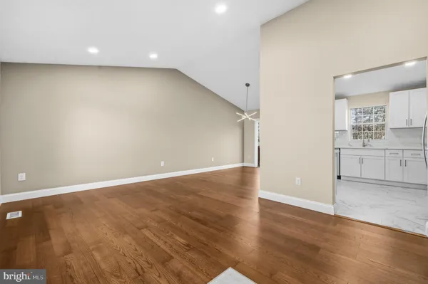 a view of a kitchen with wooden floor and a sink