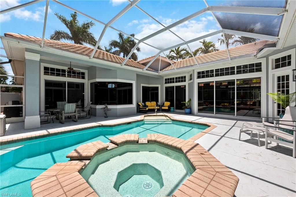 566 Eagle Creek Drive Naples, FL 34113 - Photo 1 of 25 a view of a house with a swimming pool and furniture