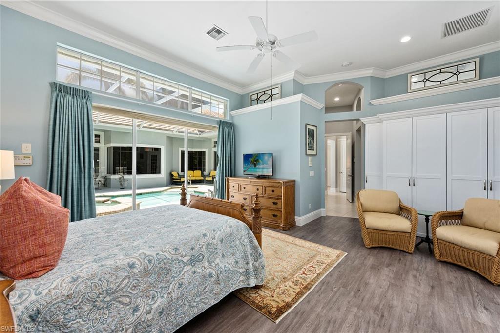 566 Eagle Creek Drive Naples, FL 34113 - Photo 11 of 25 a bedroom with a bed a couch and dresser