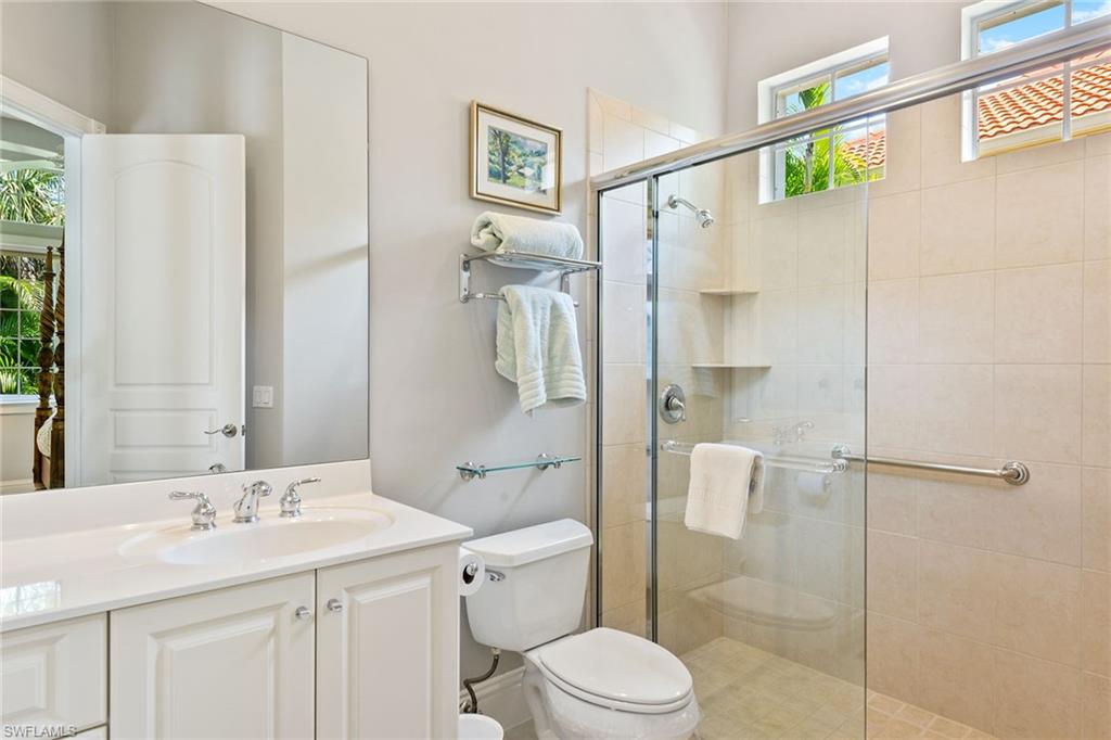 566 Eagle Creek Drive Naples, FL 34113 - Photo 15 of 25 a bathroom with a sink a toilet and shower