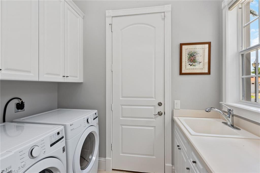 566 Eagle Creek Drive Naples, FL 34113 - Photo 18 of 25 a utility room with dryer and washer
