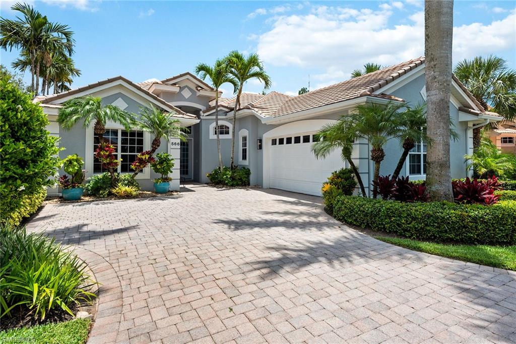 566 Eagle Creek Drive Naples, FL 34113 - Photo 2 of 25 a view of a house with potted plants and a large tree
