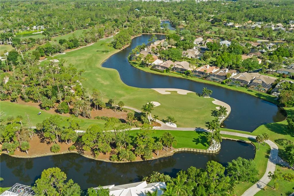 566 Eagle Creek Drive Naples, FL 34113 - Photo 22 of 25 an aerial view of a house with a yard and lake view