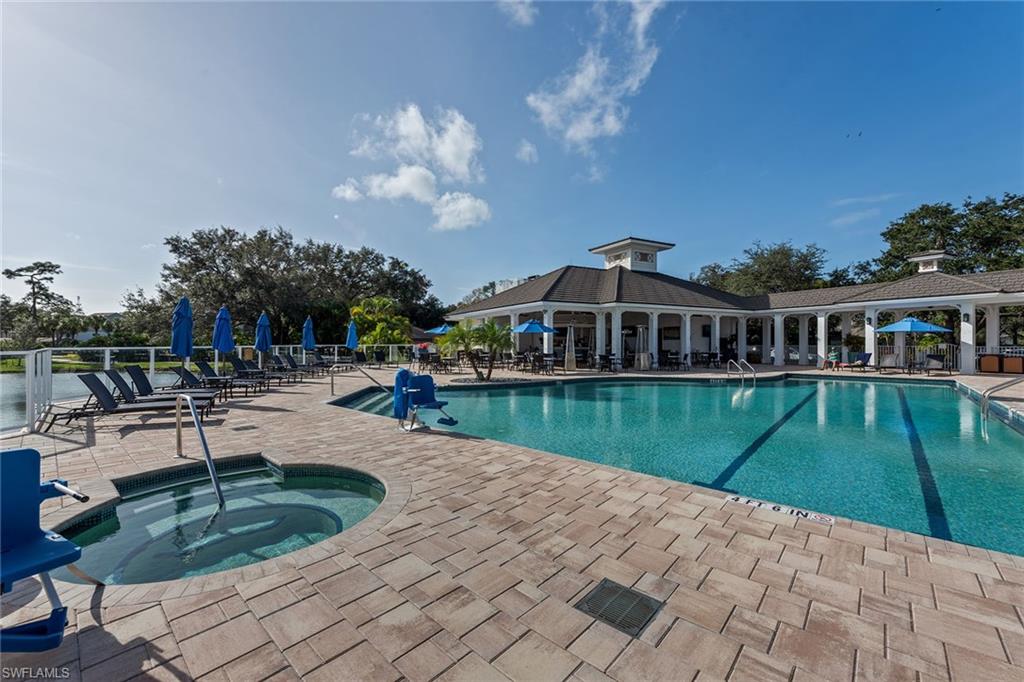 566 Eagle Creek Drive Naples, FL 34113 - Photo 24 of 25 a view of a house with pool and sitting area