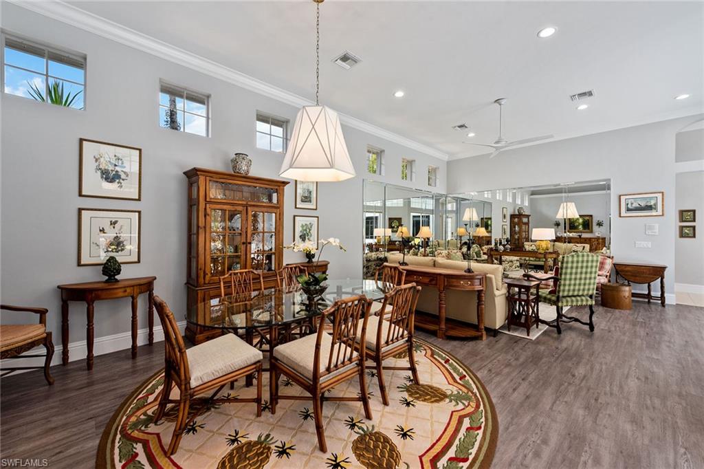 566 Eagle Creek Drive Naples, FL 34113 - Photo 4 of 25 a dining room a table and chairs