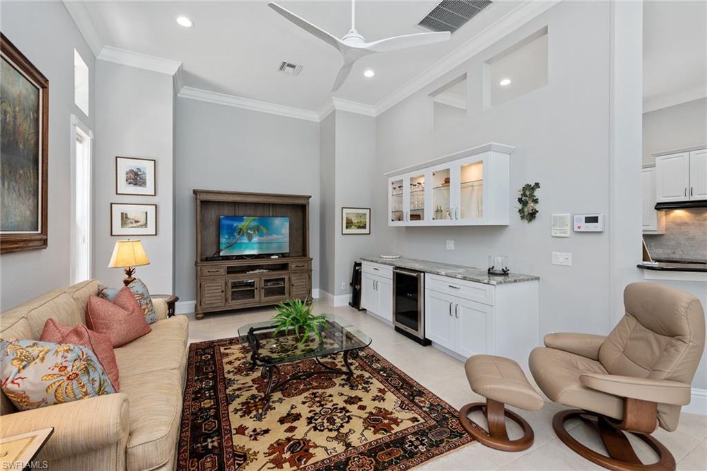 566 Eagle Creek Drive Naples, FL 34113 - Photo 8 of 25 a living room with furniture and a flat screen tv