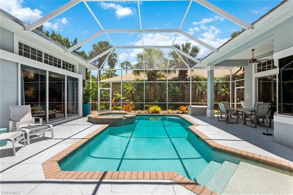 566 Eagle Creek Drive Naples, FL 34113 - Photo 9 of 25 a view of swimming pool with dining room and wooden floor