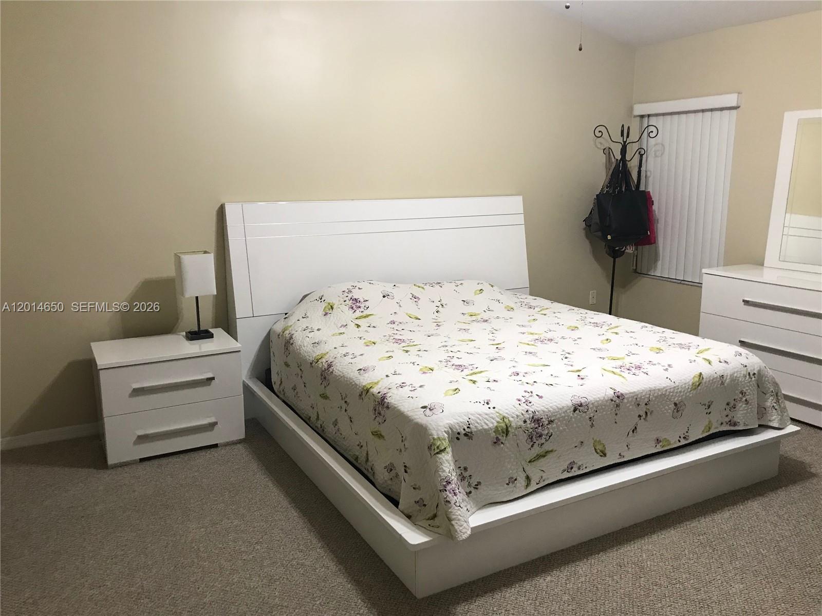 16654 Southwest 103rd Lane Miami, FL 33196 - Photo 14 of 20 a bedroom with a bed and window