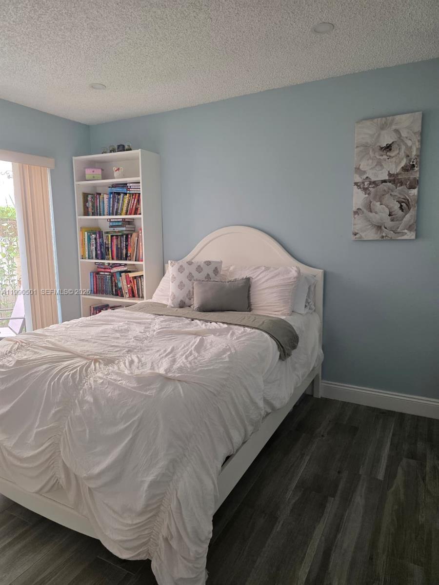 893 Southwest 120th Way Davie, FL 33325 - Photo 16 of 22 a bedroom with a bed and a window