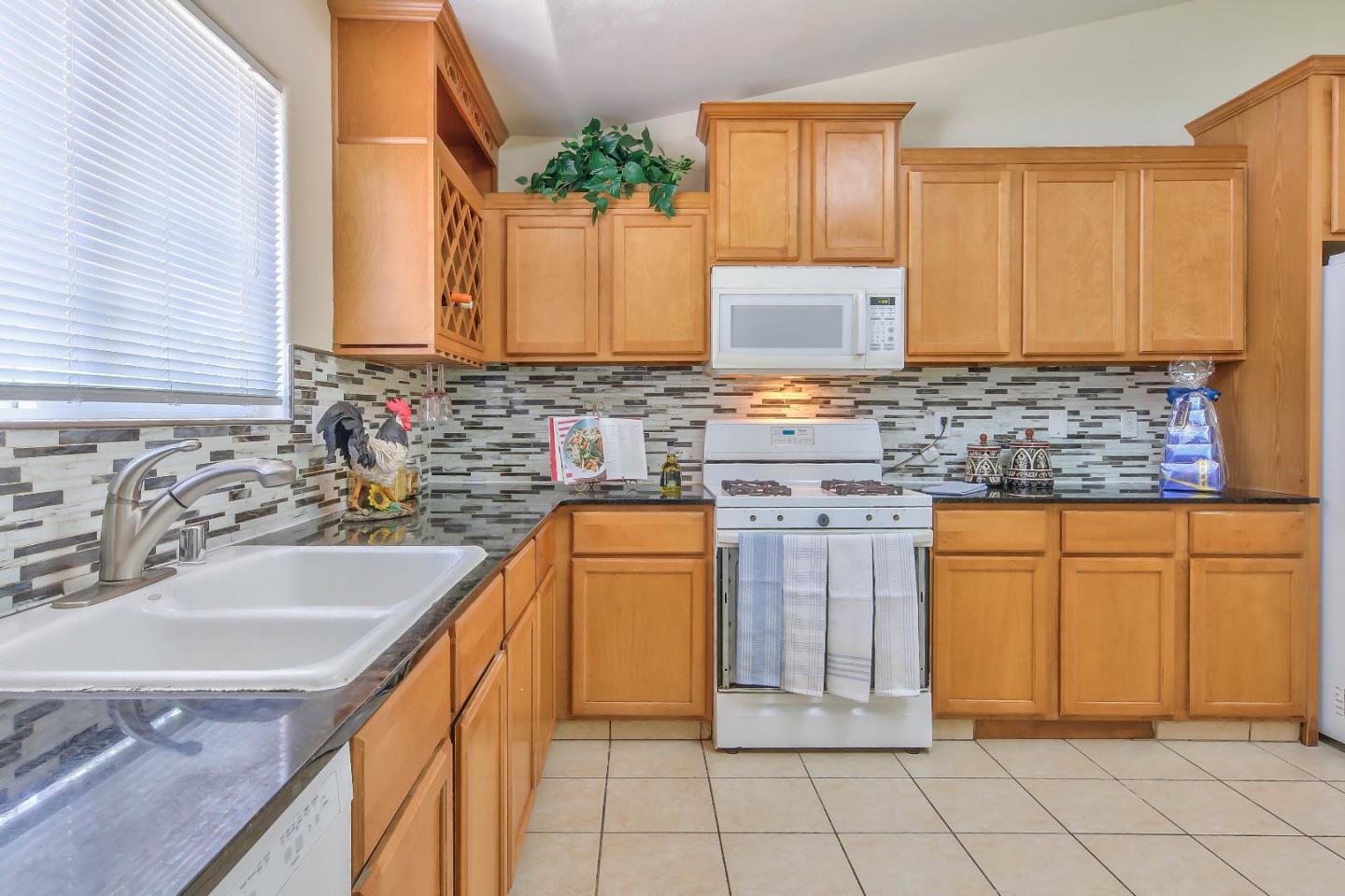 5502 Mesa Road Gilroy, CA 95020 - Photo 11 of 23 a bathroom with a granite countertop sink and a mirror