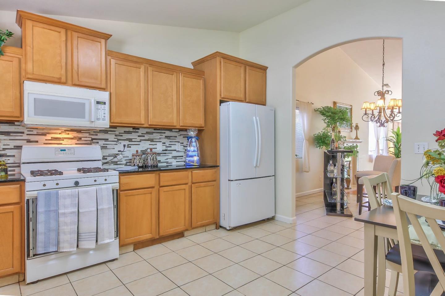 5502 Mesa Road Gilroy, CA 95020 - Photo 12 of 23 a kitchen with stainless steel appliances granite countertop a refrigerator sink and cabinets