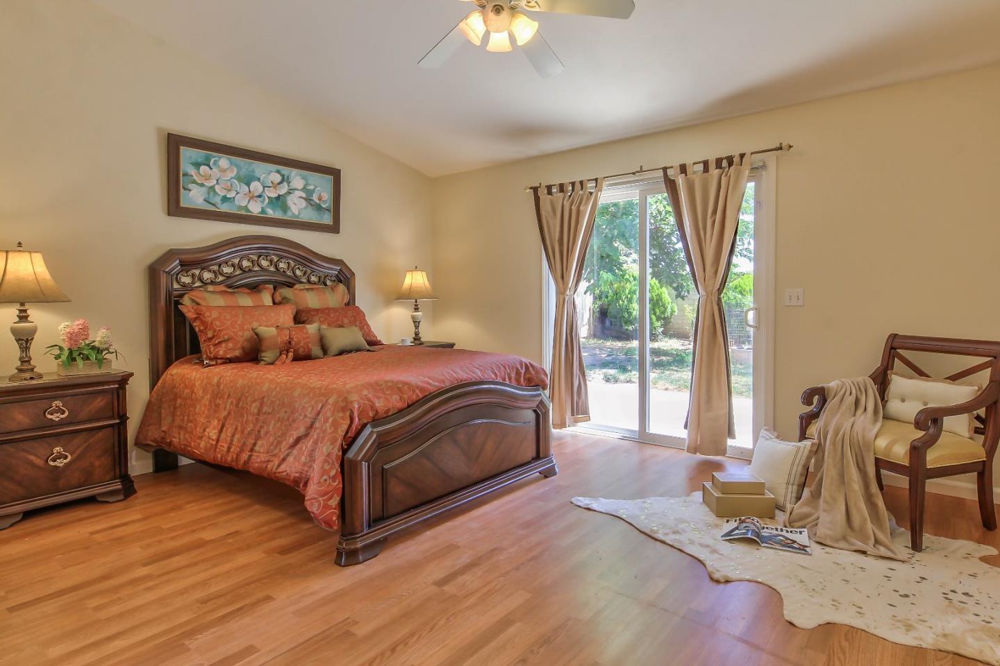 5502 Mesa Road Gilroy, CA 95020 - Photo 13 of 23 a bedroom with a bed and glass windows