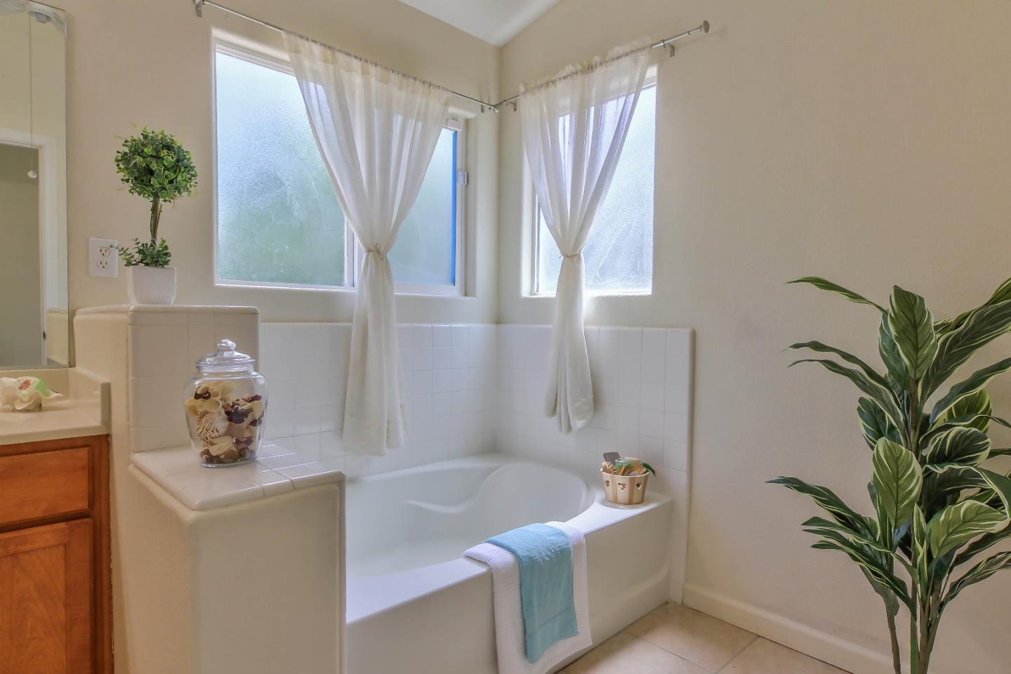 5502 Mesa Road Gilroy, CA 95020 - Photo 16 of 23 a bathroom with a tub sink and mirror