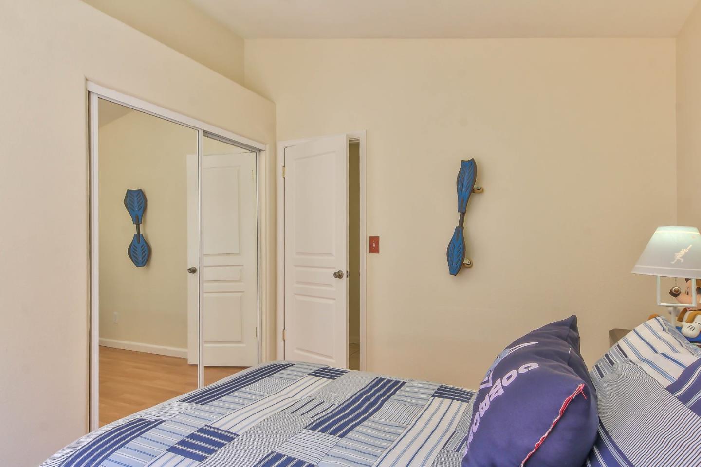 5502 Mesa Road Gilroy, CA 95020 - Photo 19 of 23 a bedroom with a bed and a wooden floor