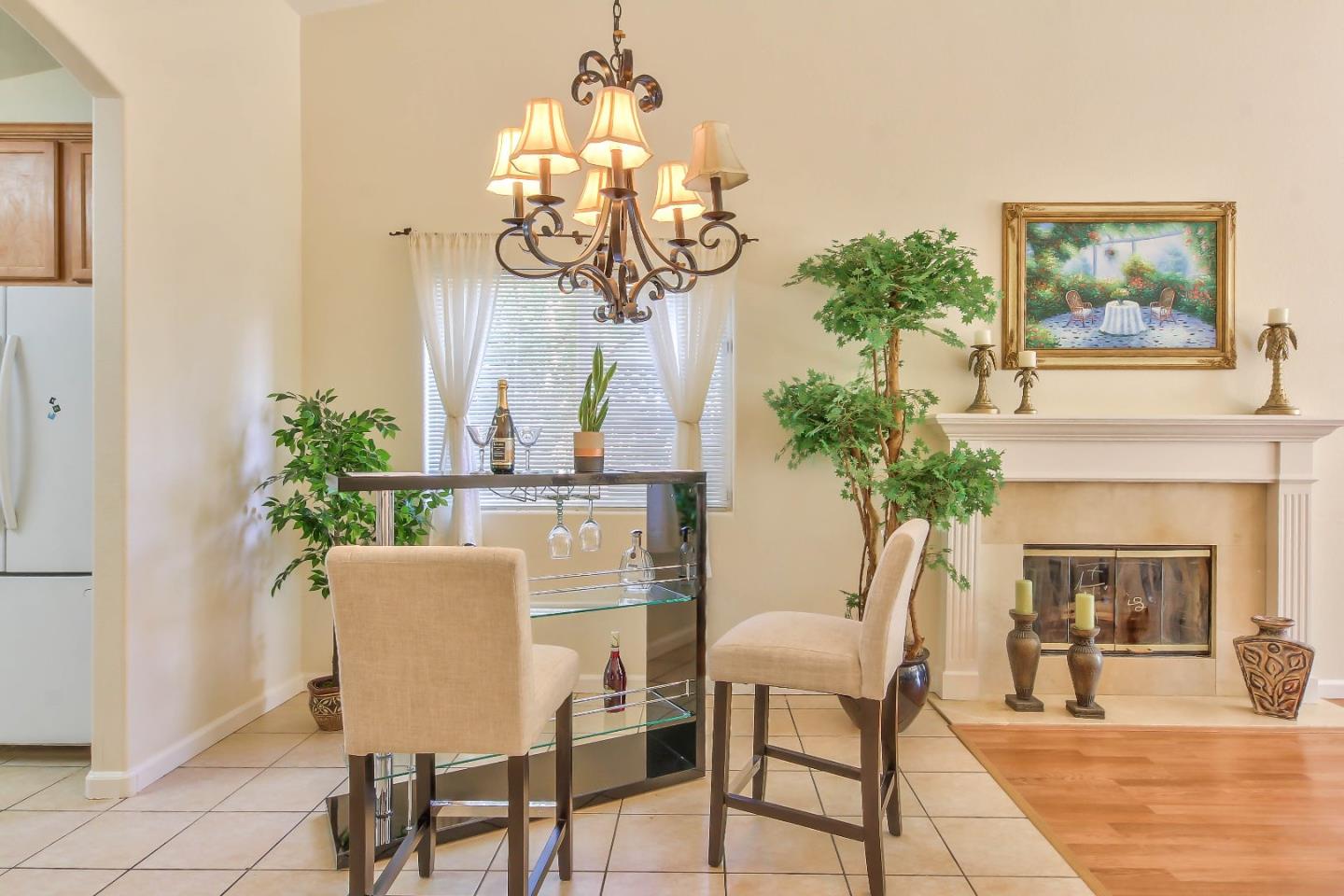 5502 Mesa Road Gilroy, CA 95020 - Photo 7 of 23 a dining room with furniture potted plants and a chandelier