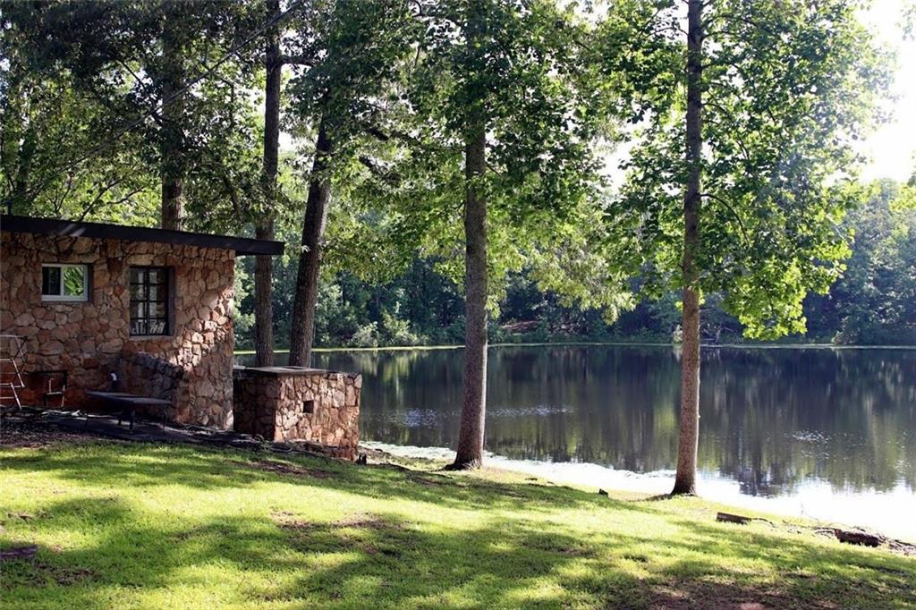 415 Walton Road Barnesville, GA 30204 - Photo 2 of 12 a swimming pool with outdoor seating and yard
