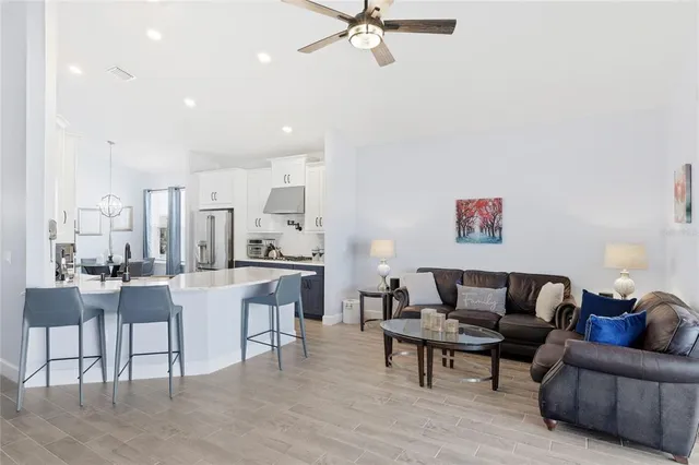 a bathroom with a tub a sink double vanity and a mirror