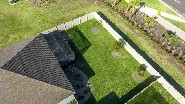a front view of a house with a yard and potted plants