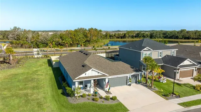 a view of a sign board with buildings in the background