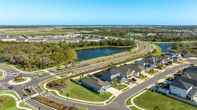 a sign board with building in the background