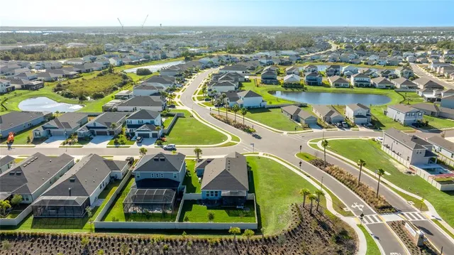 a kitchen with a sink stove cabinets and wooden floor