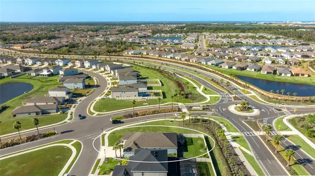 a living room with furniture a flat screen tv and a large window