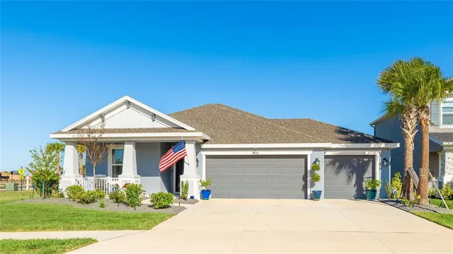 a view of a a dining room with furniture window and wooden floor