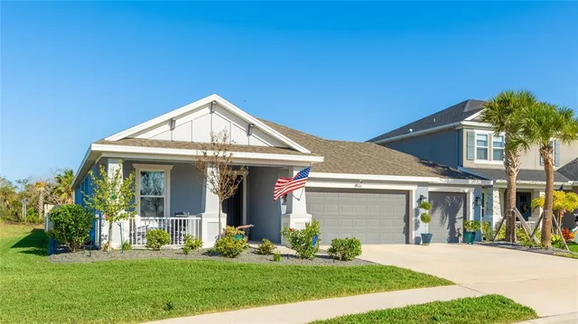 an aerial view of a house with garden space and a car park in front of house