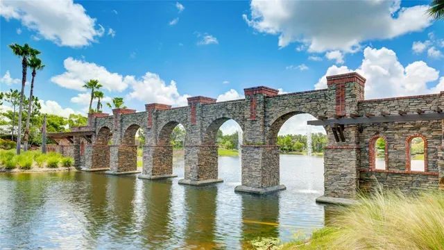 an aerial view of a swimming pool with outdoor seating