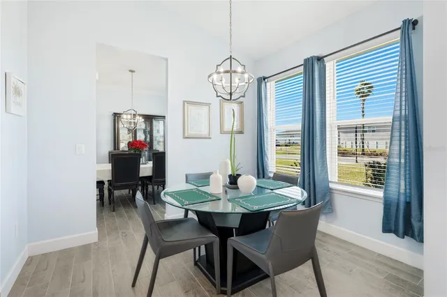 a kitchen with stainless steel appliances kitchen island granite countertop a dining table and chairs