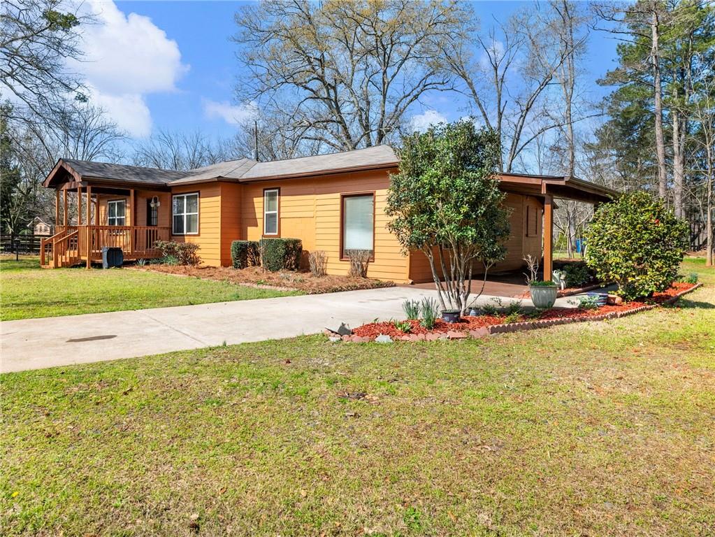 1686 Shoal Creek Road Monroe, GA 30656 - Photo 28 of 50 a view of a house with a big yard and large tree