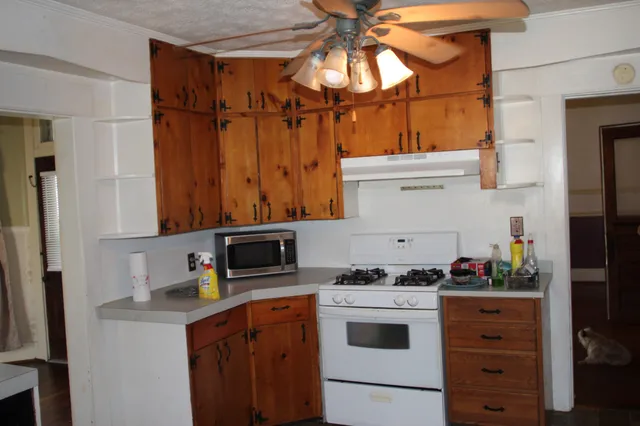 a kitchen with stainless steel appliances a stove and a refrigerator