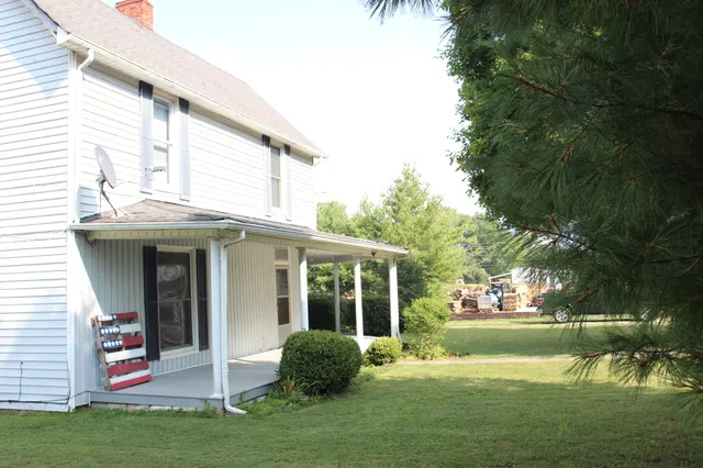 a view of a house with backyard porch and sitting area