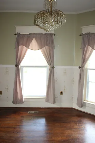 a view of a bedroom with a window and a door