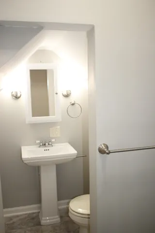 a view of a house with a backyard and a tree