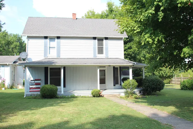 a view of a house with a yard and sitting area