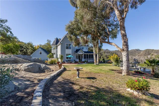 a living room with furniture a chandelier a piano and a flat screen tv