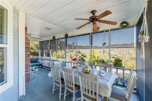 a dining room with furniture a chandelier and window