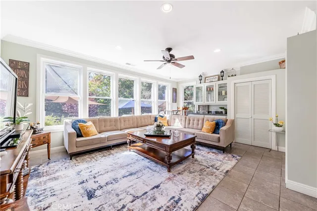 a view of a house with a yard and potted plants