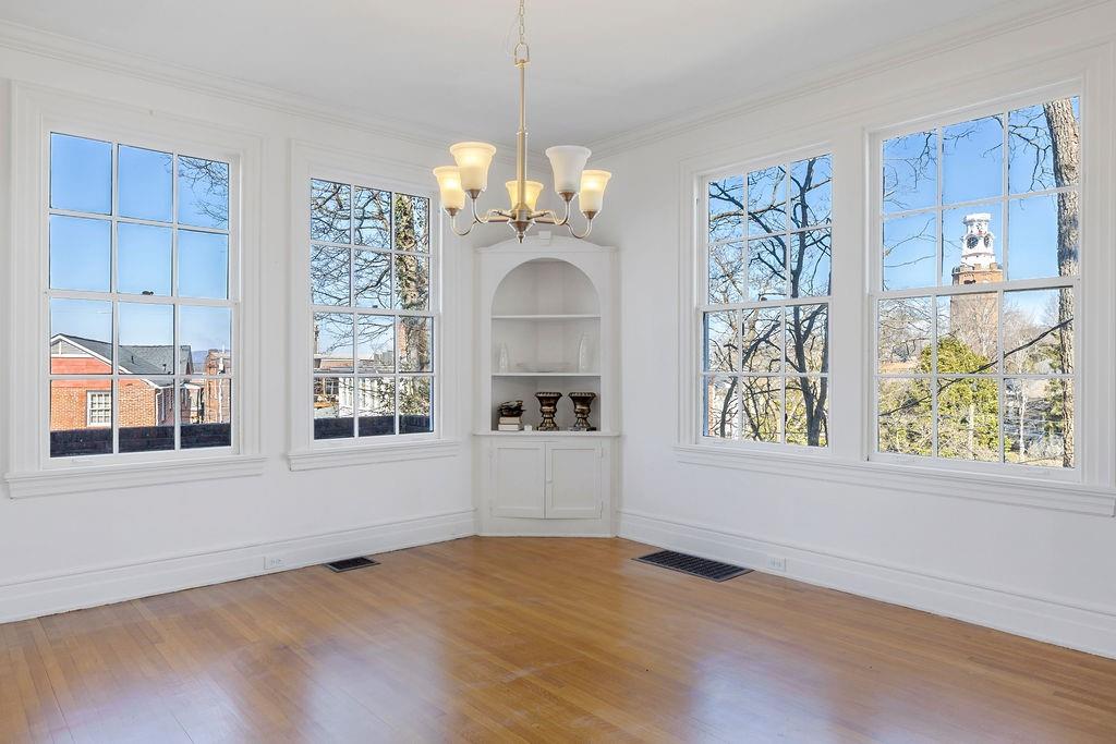 312 East 3rd Street Rome, GA 30161 - Photo 12 of 42 an empty room with windows and chandelier