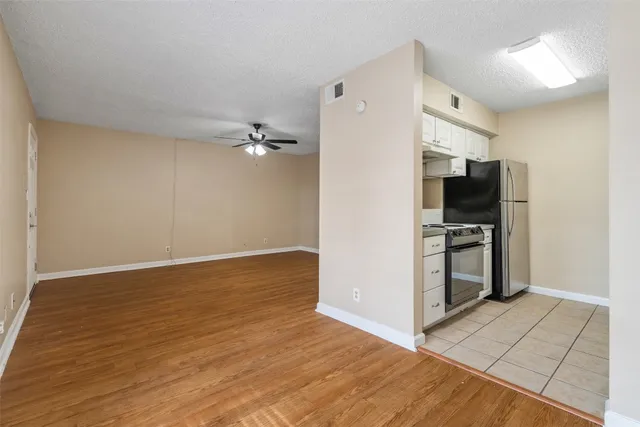 a view of a kitchen with refrigerator and microwave