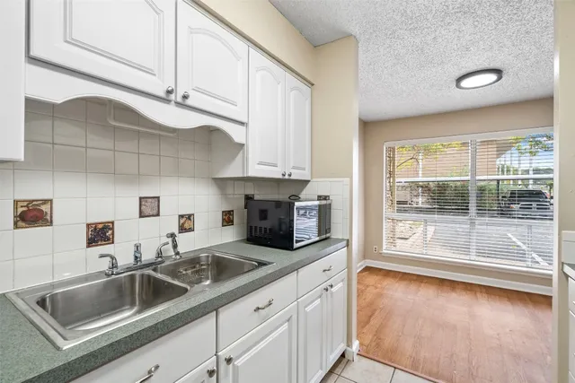 a kitchen with sink cabinets and outdoor view