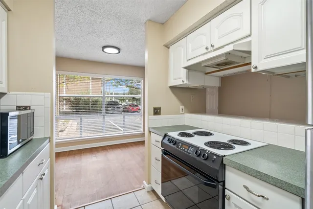 a kitchen with a stove and a microwave