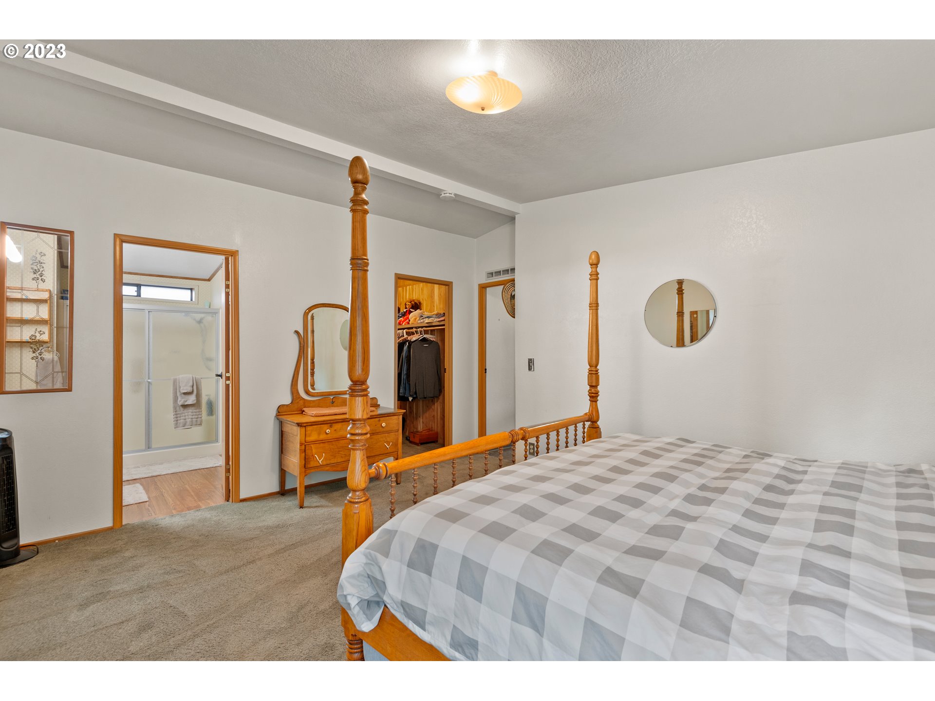 19119 Kelsey Marie Lane Southwest Rochester, WA 98579 - Photo 12 of 29 a bedroom with a bed and a dresser with mirror
