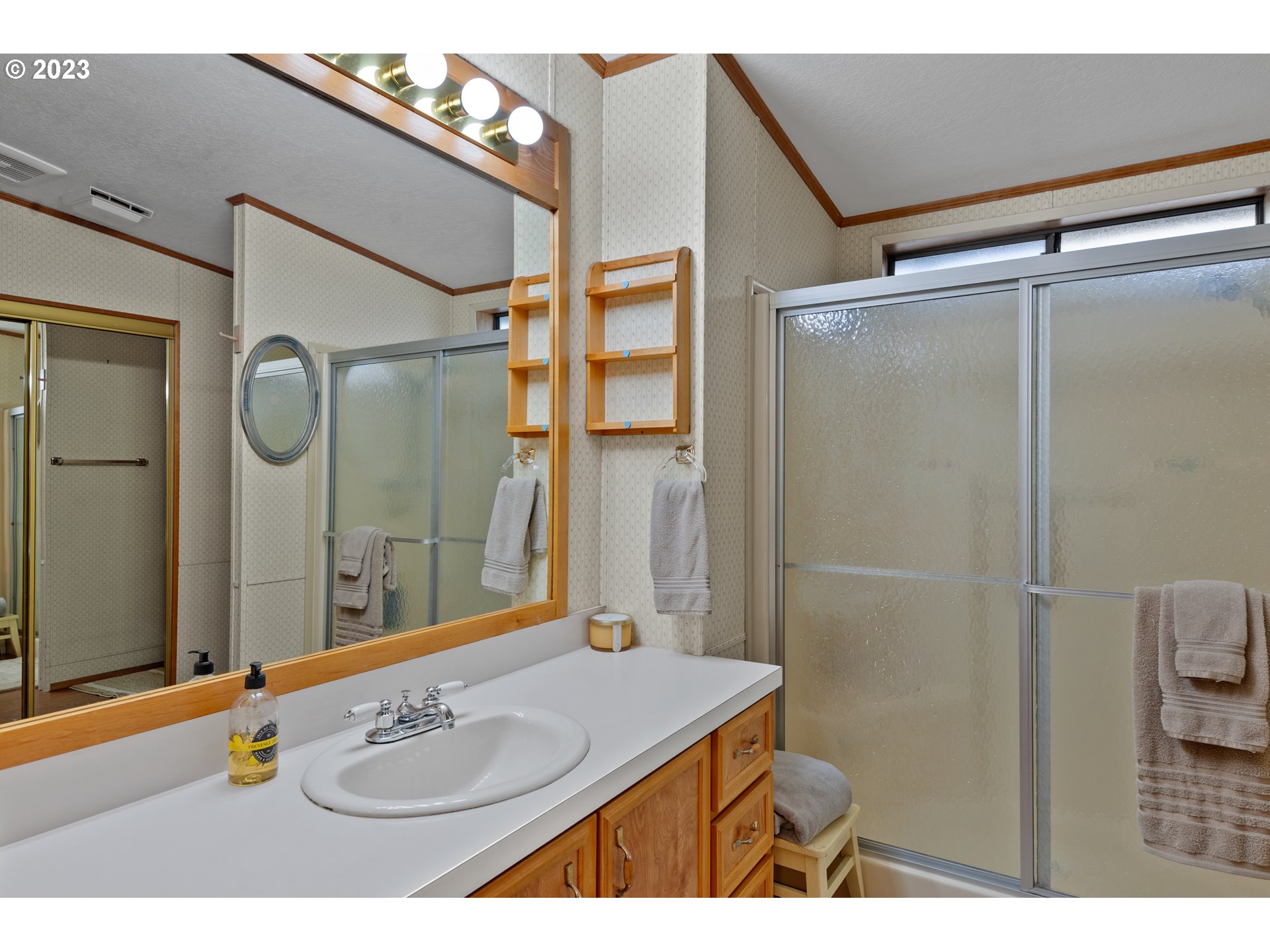 19119 Kelsey Marie Lane Southwest Rochester, WA 98579 - Photo 13 of 29 a bathroom with a sink mirror and a shower