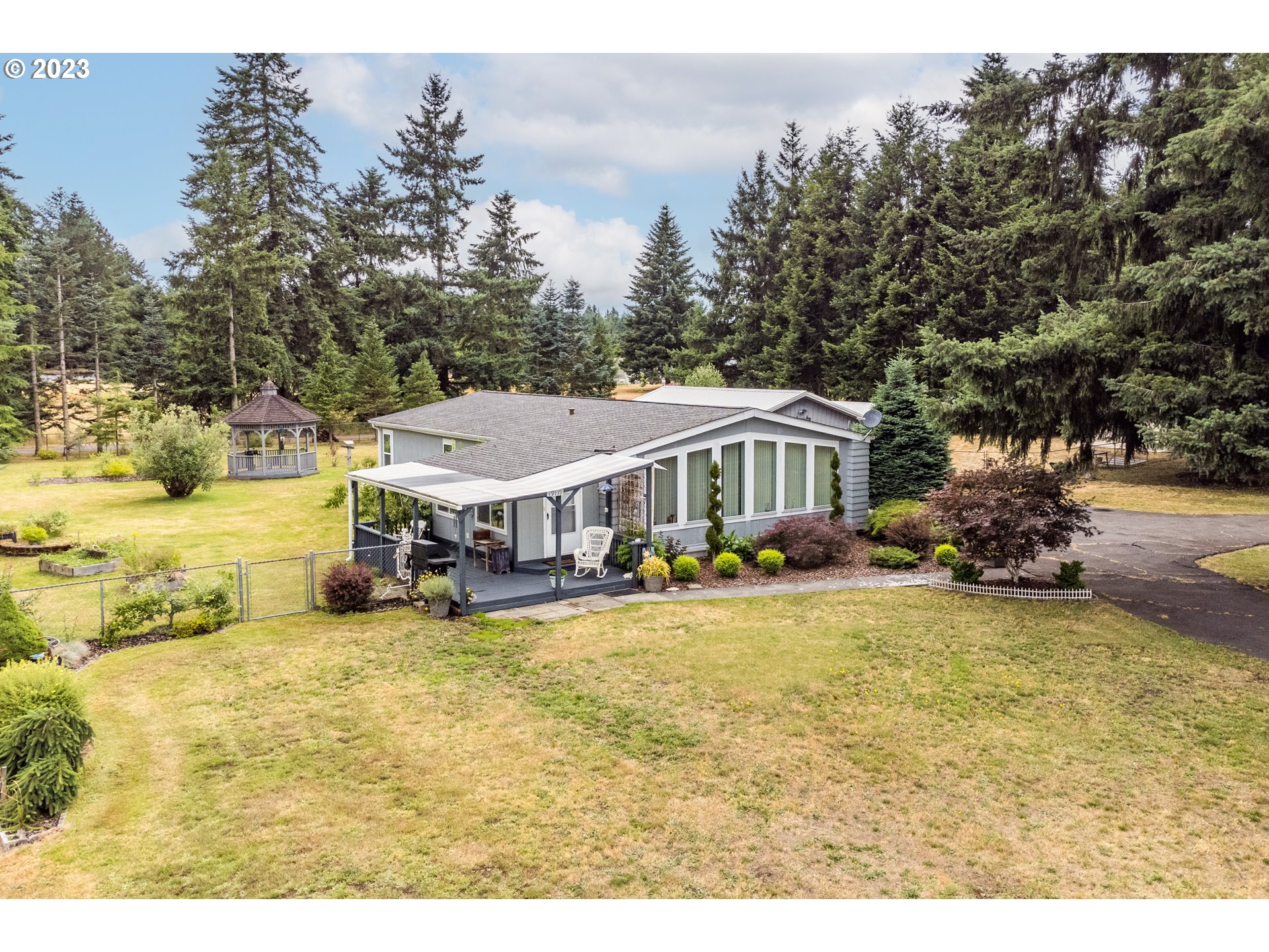 19119 Kelsey Marie Lane Southwest Rochester, WA 98579 - Photo 26 of 29 a view of a house with swimming pool and sitting area