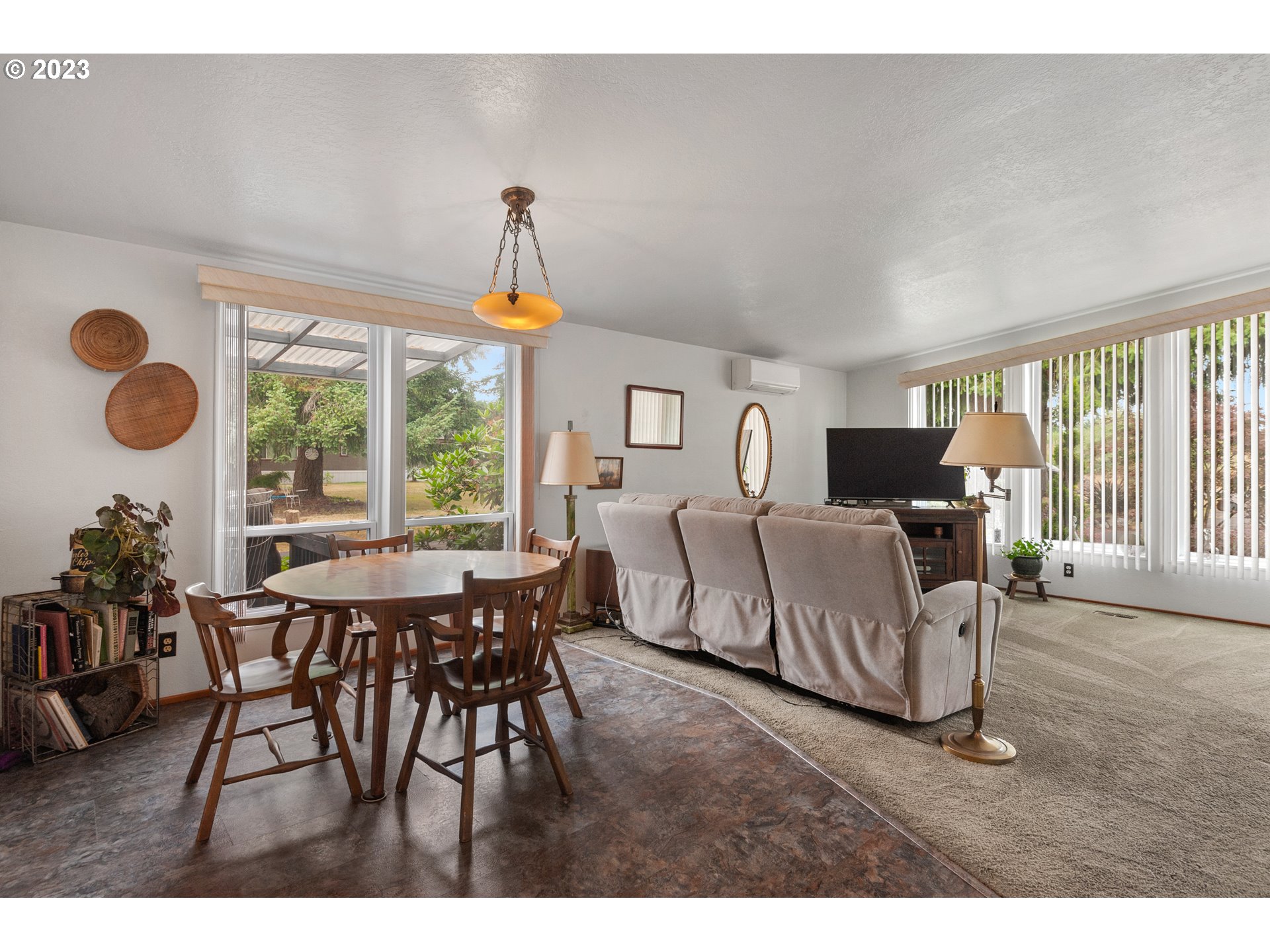 19119 Kelsey Marie Lane Southwest Rochester, WA 98579 - Photo 7 of 29 a view of a dining room and livingroom with furniture wooden floor a chandelier